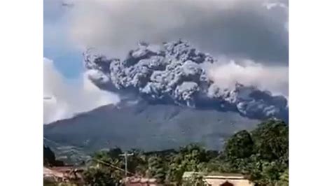 Philippine volcano briefly erupts, belching ash plume into the sky.